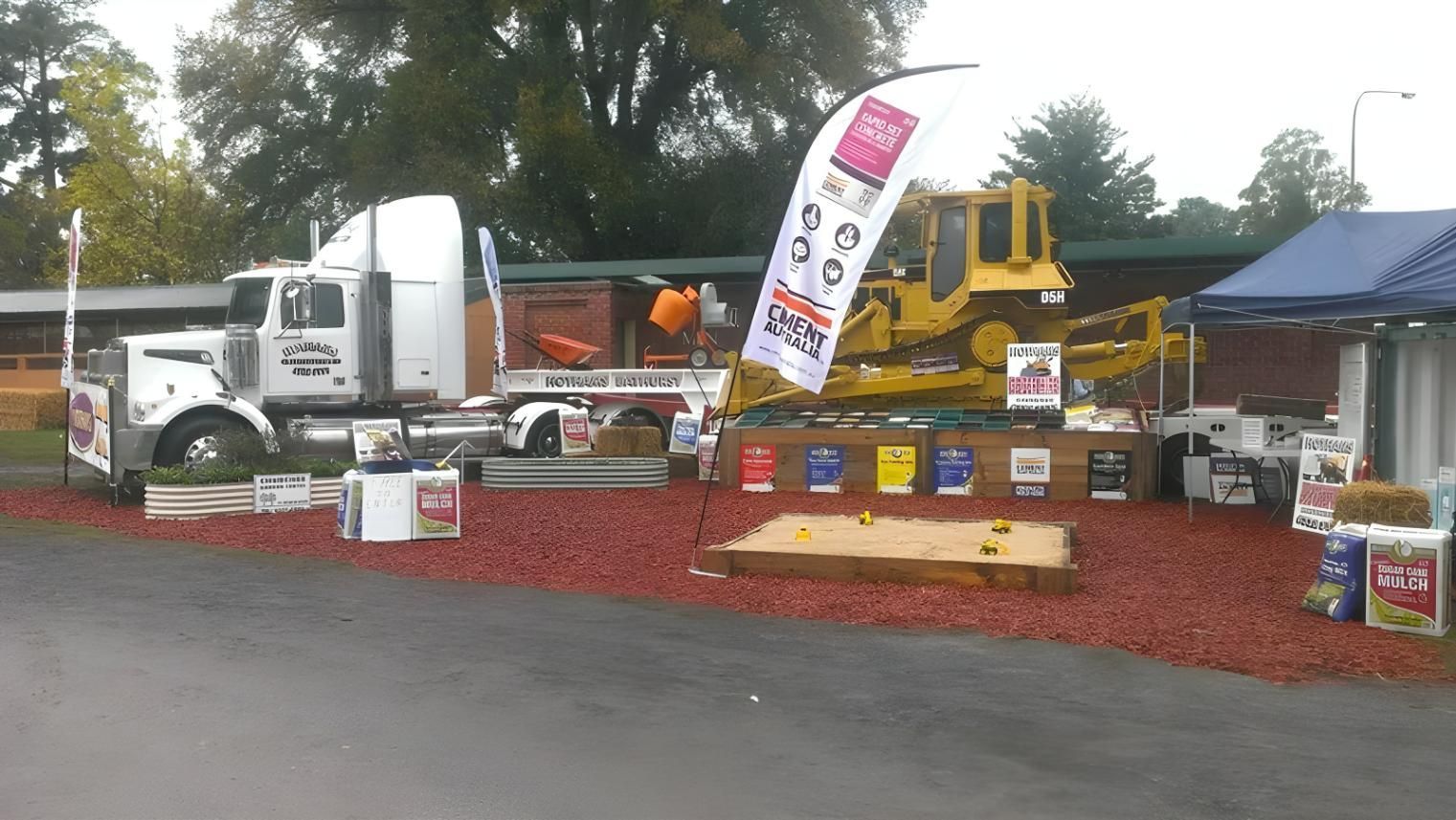 A White Semi Truck is Parked Next to a Yellow Bulldozer — Hothams In Bathurst, NSW