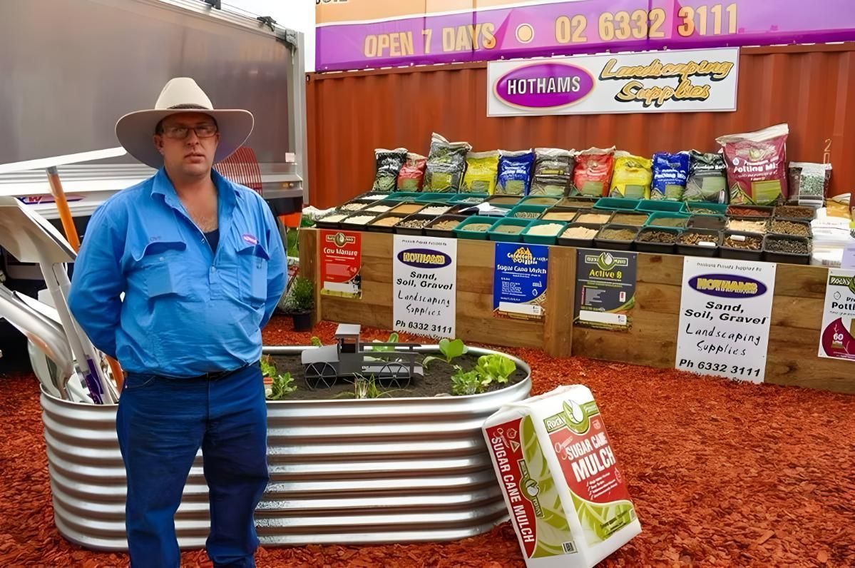 A Man in a Cowboy Hat Stands in Front of a Sign That Says Open 7 Days — Hothams In Bathurst, NSW