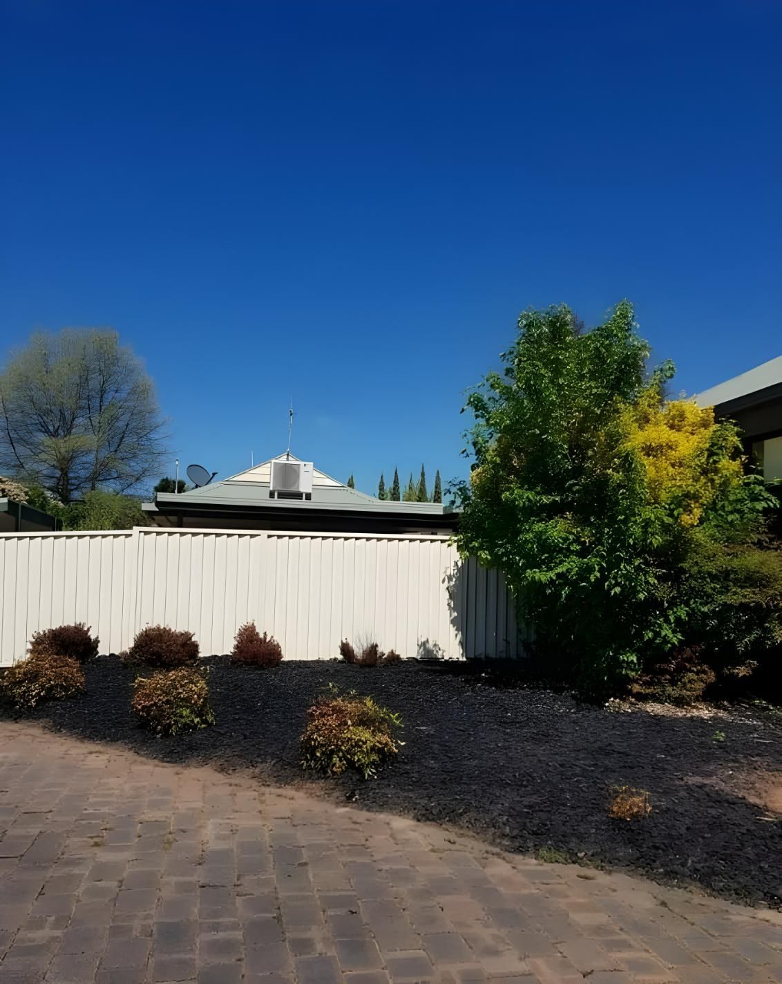 A House With a White Fence and a Blue Sky in the Background — Hothams In Bathurst, NSW