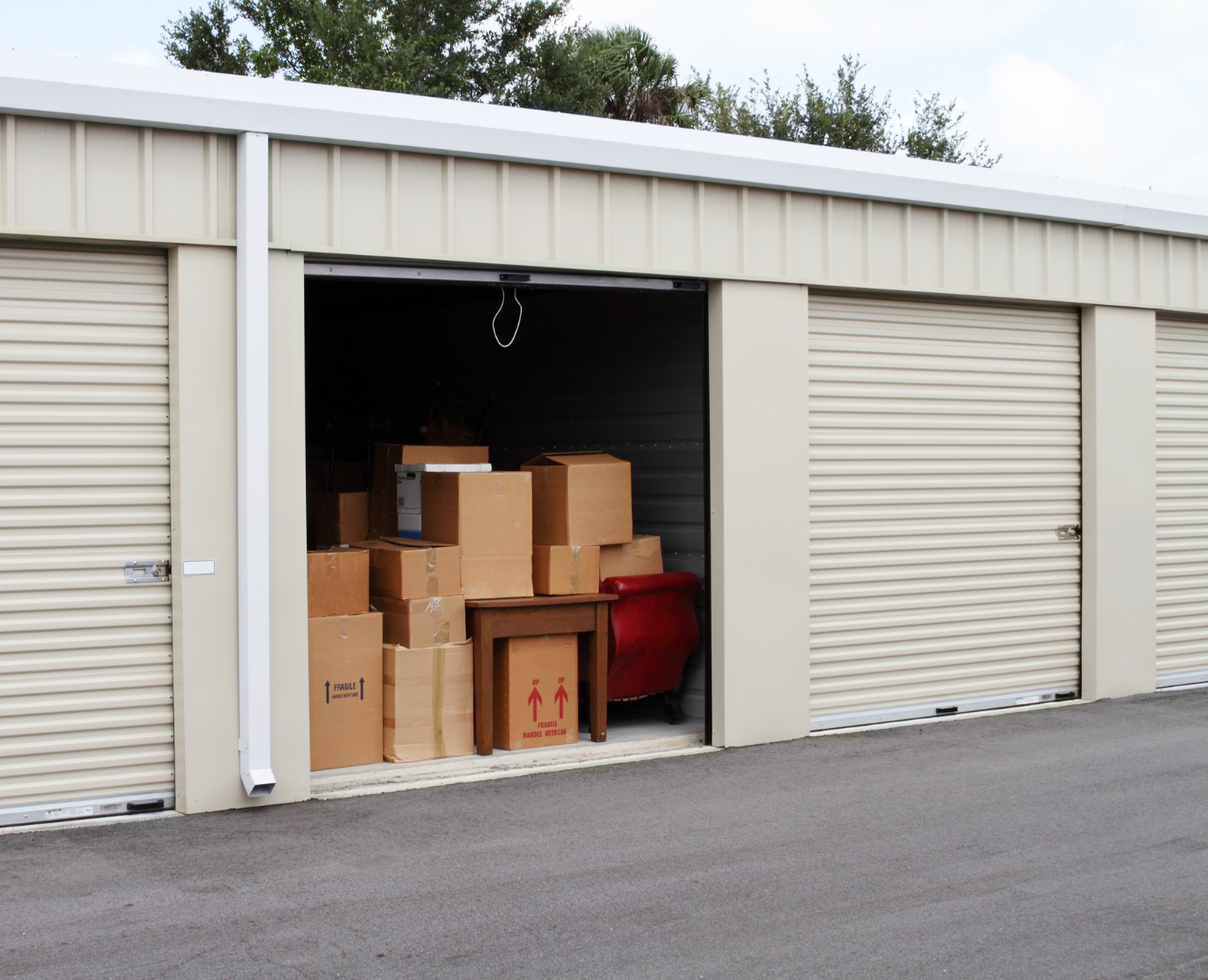 Storage unit filled with cardboard boxes and furniture.
