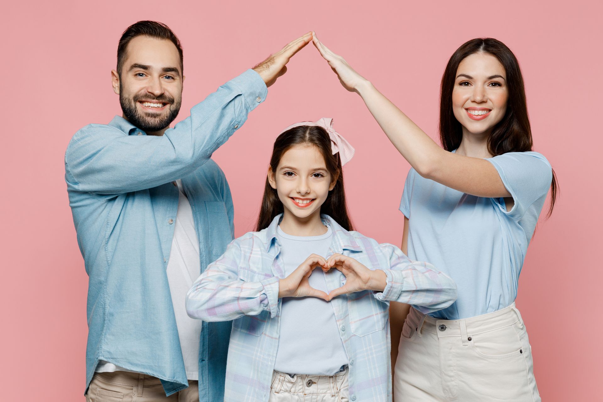 Family makes heart and house shapes, symbolizing love and home insurance protection.