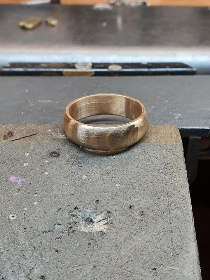 Gold Ring on a Textured, Grey Surface — Chris Williams Retail & Manufacturing Jewellers in Wanguri, NT