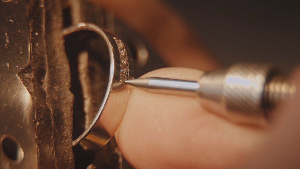 A Jeweler Uses a Precision Metal Tool to Set a Diamond — Chris Williams Retail & Manufacturing Jewellers in Wanguri, NT