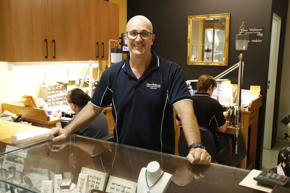 Man in a Jewelry Store, Smiling at the Counter — Chris Williams Retail & Manufacturing Jewellers in Wanguri, NT