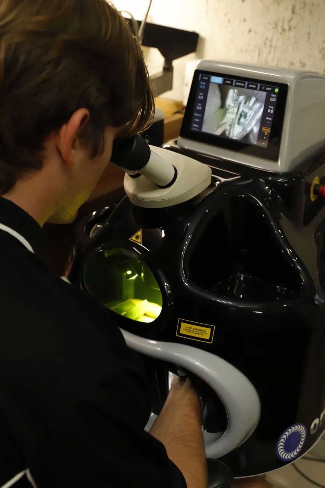 Person Looking Into a Microscope and Rings — Chris Williams Retail & Manufacturing Jewellers in Wanguri, NT