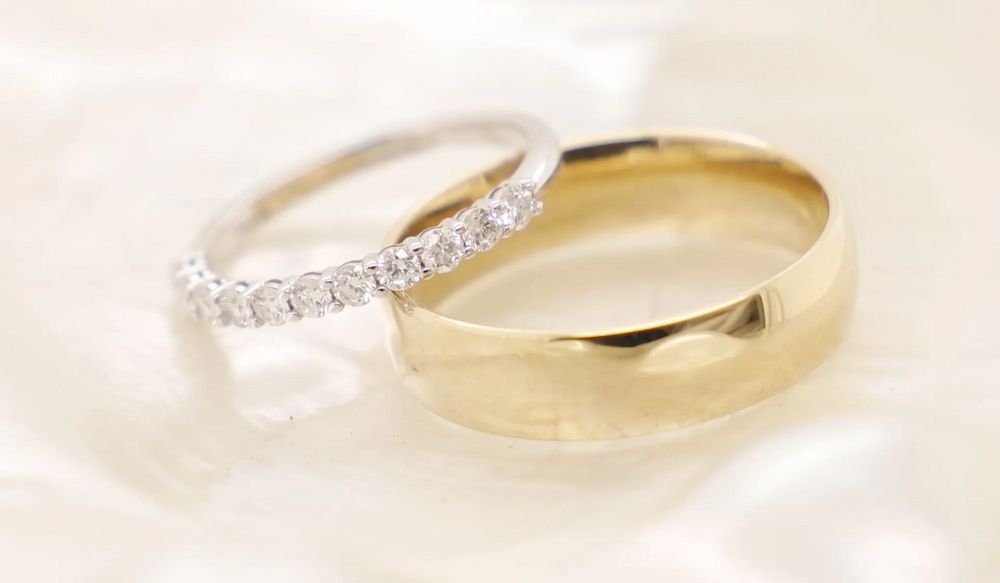 Gold Wedding Band Next to a White Gold Ring With Diamonds — Chris Williams Retail & Manufacturing Jewellers in Wanguri, NT