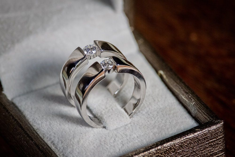 Two Silver Rings With Single Inset Stones Resting — Chris Williams Retail & Manufacturing Jewellers in Wanguri, NT