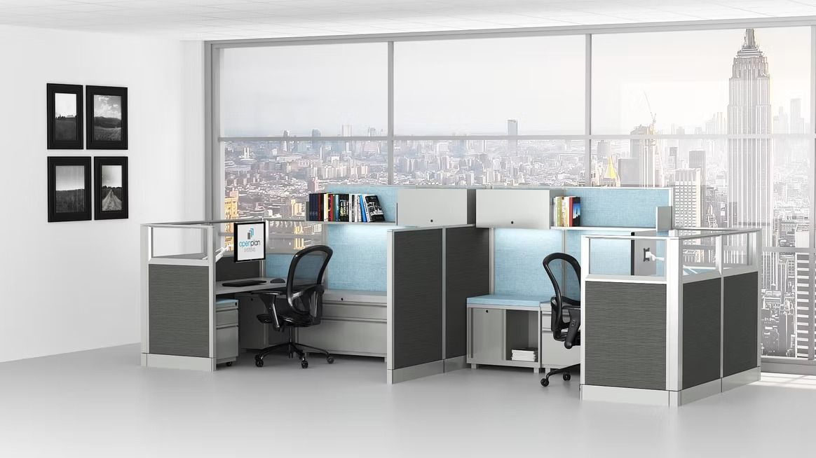 A cubicle in an office with a view of the city.