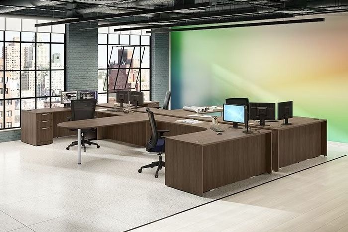 A large office with a lot of desks and chairs and computers.
