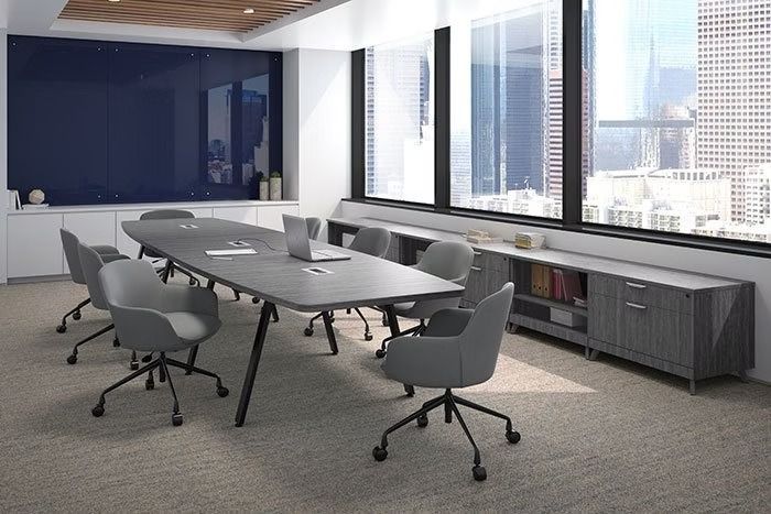 A conference room with a long table and chairs and a large window.