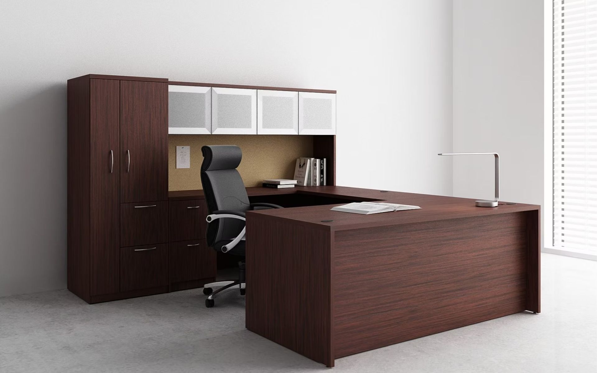 A wooden desk with a black chair in an office