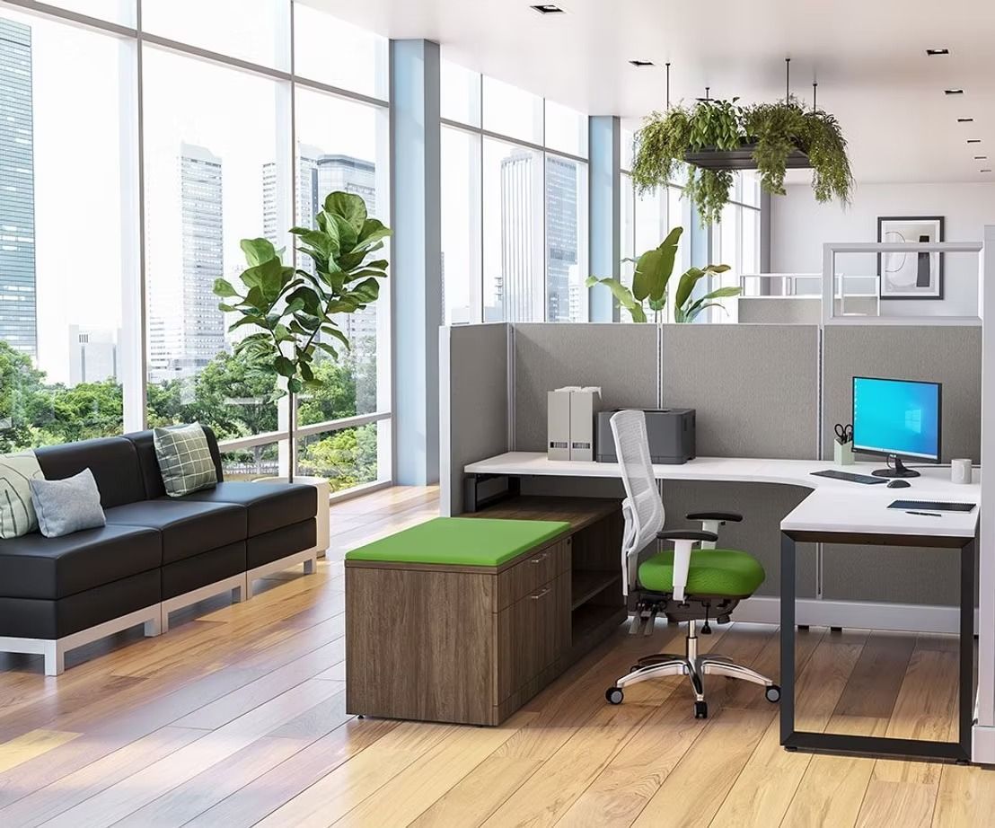 An office with a couch , desk , chair and computer.