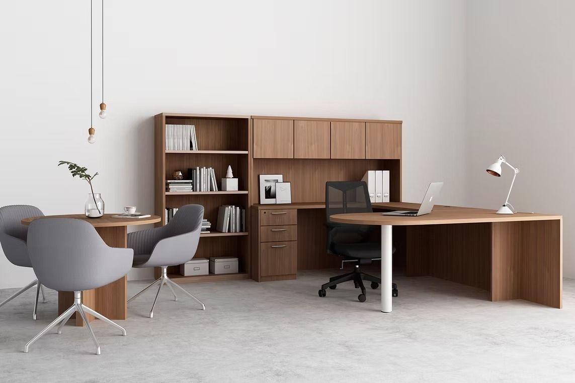 There is a desk with a laptop on it in the middle of the room.