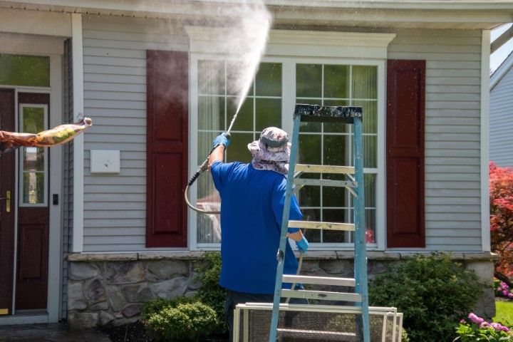 Technician cleaning window of a home in Sugar Land