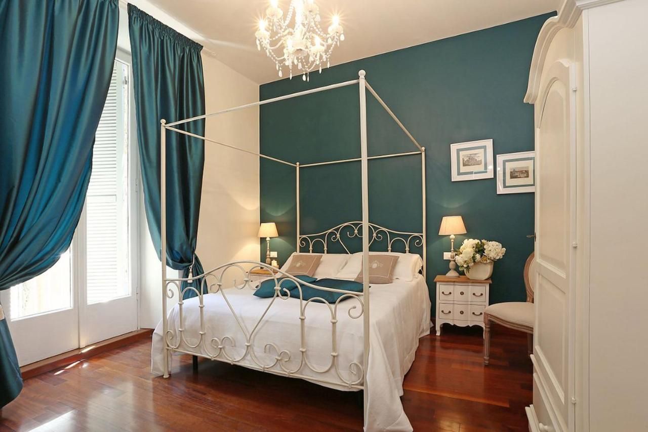 a bedroom with a four-poster bed and blue walls