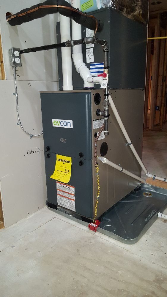A gas heater is sitting on the floor in a room.