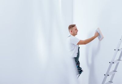 Handyman painting wall