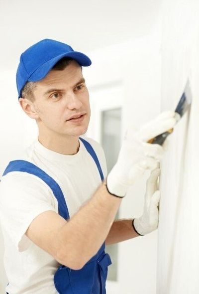 handyman plastering a wall filling