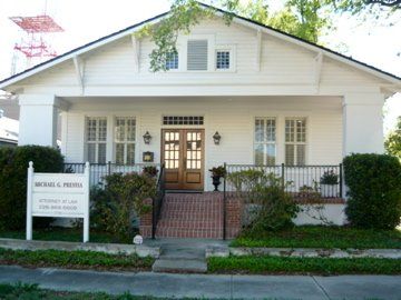 White building with brown doors and sign,
