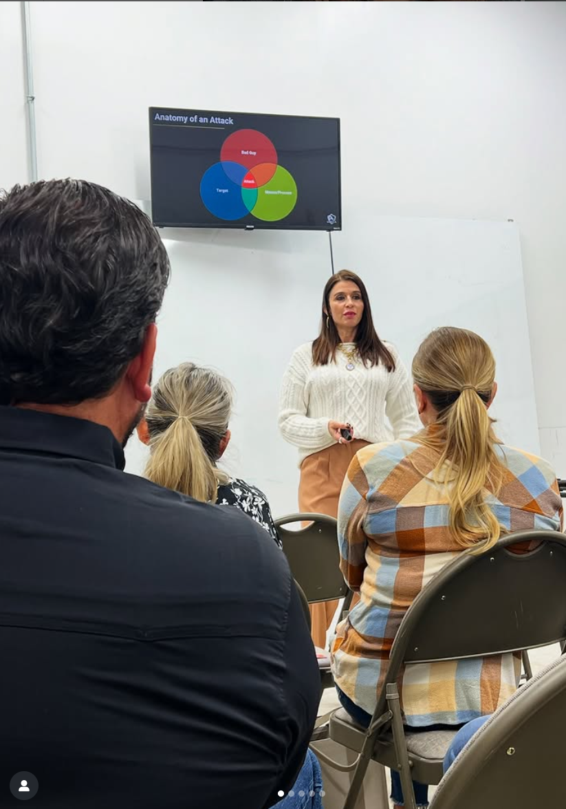 A woman is giving a presentation to a group of people sitting in chairs.