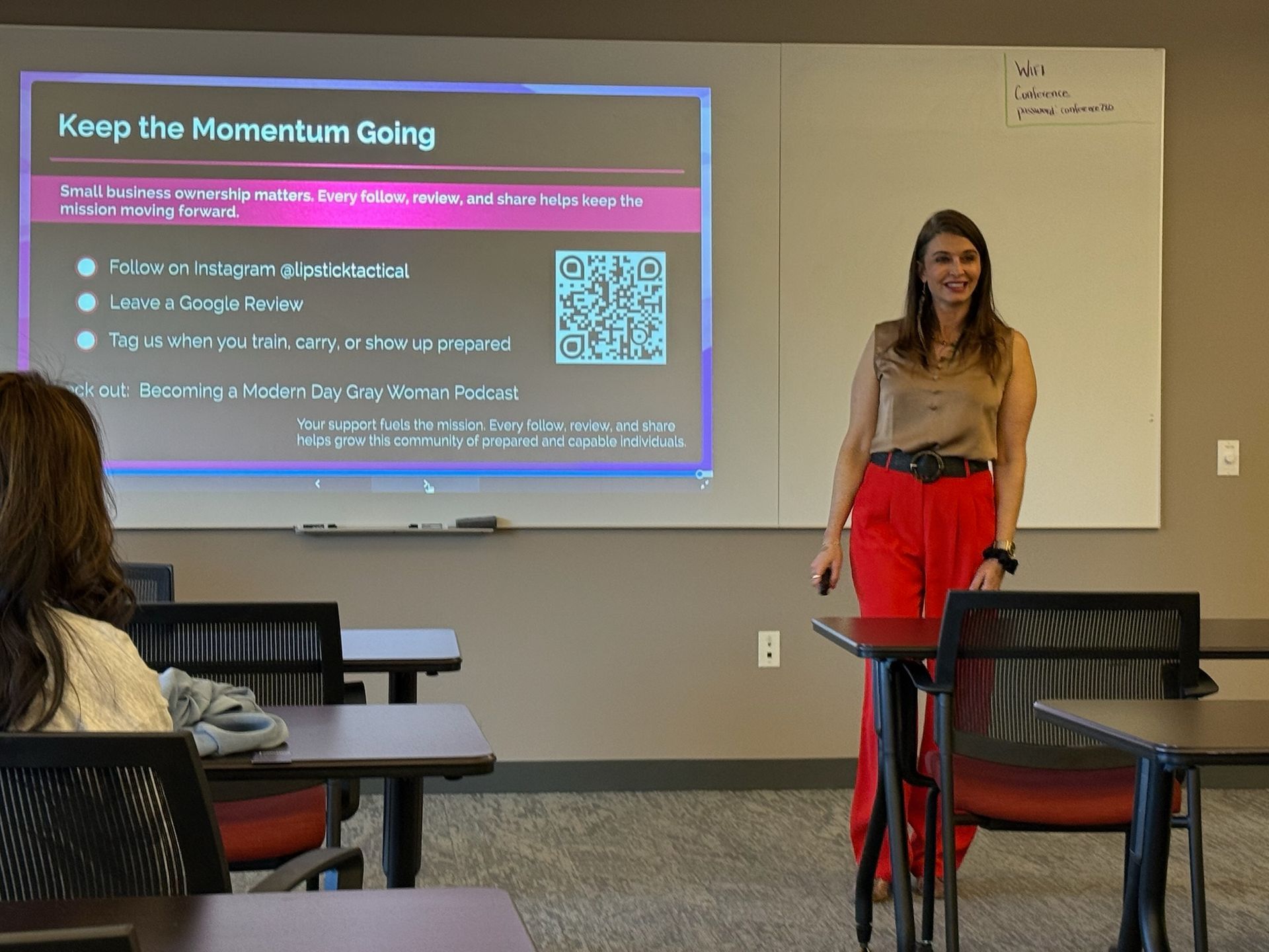 Woman at indoor gun range practicing firearm safety at Avenir Consulting training facility