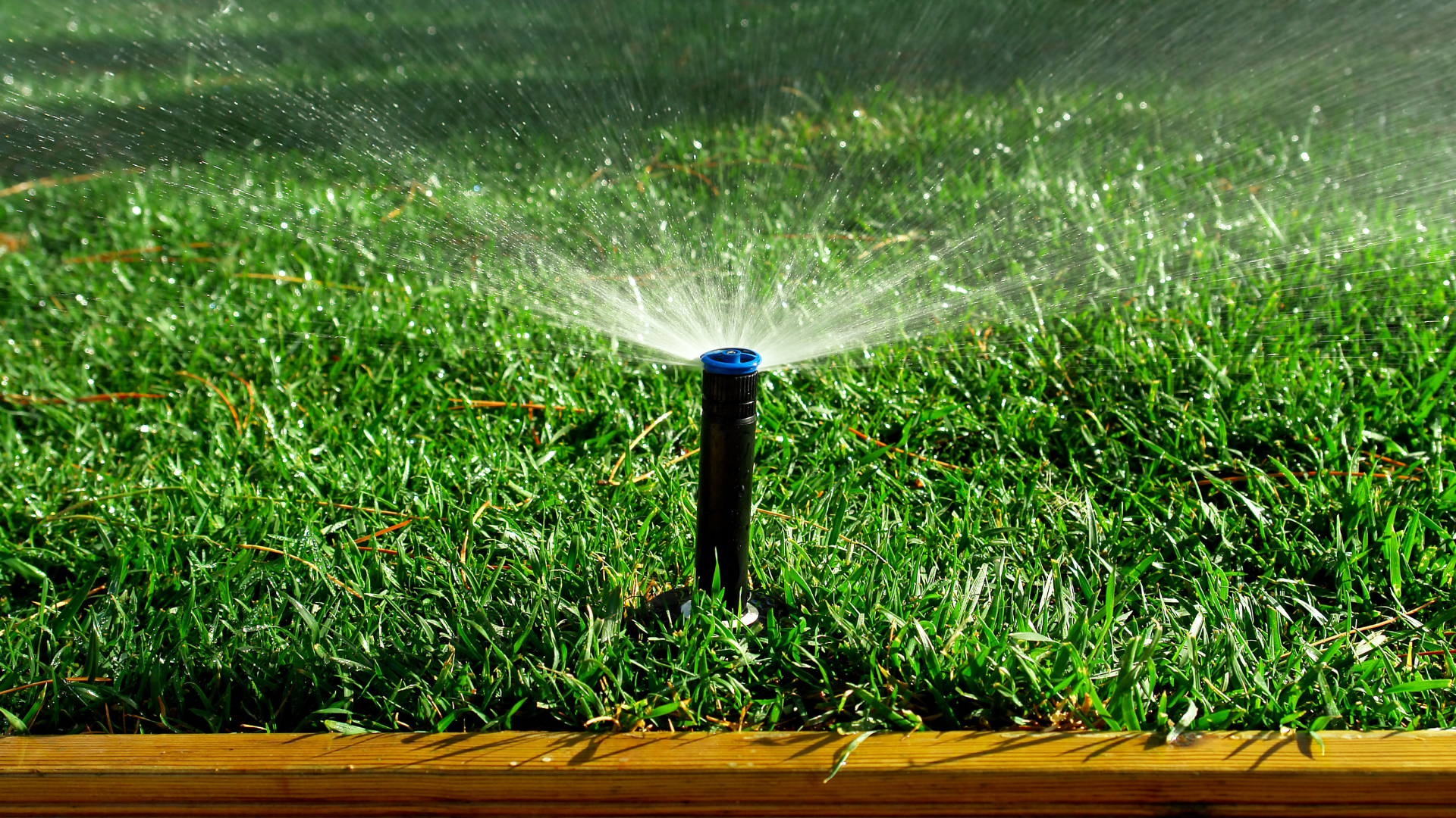 A person is holding a digital multimeter next to a water heater.