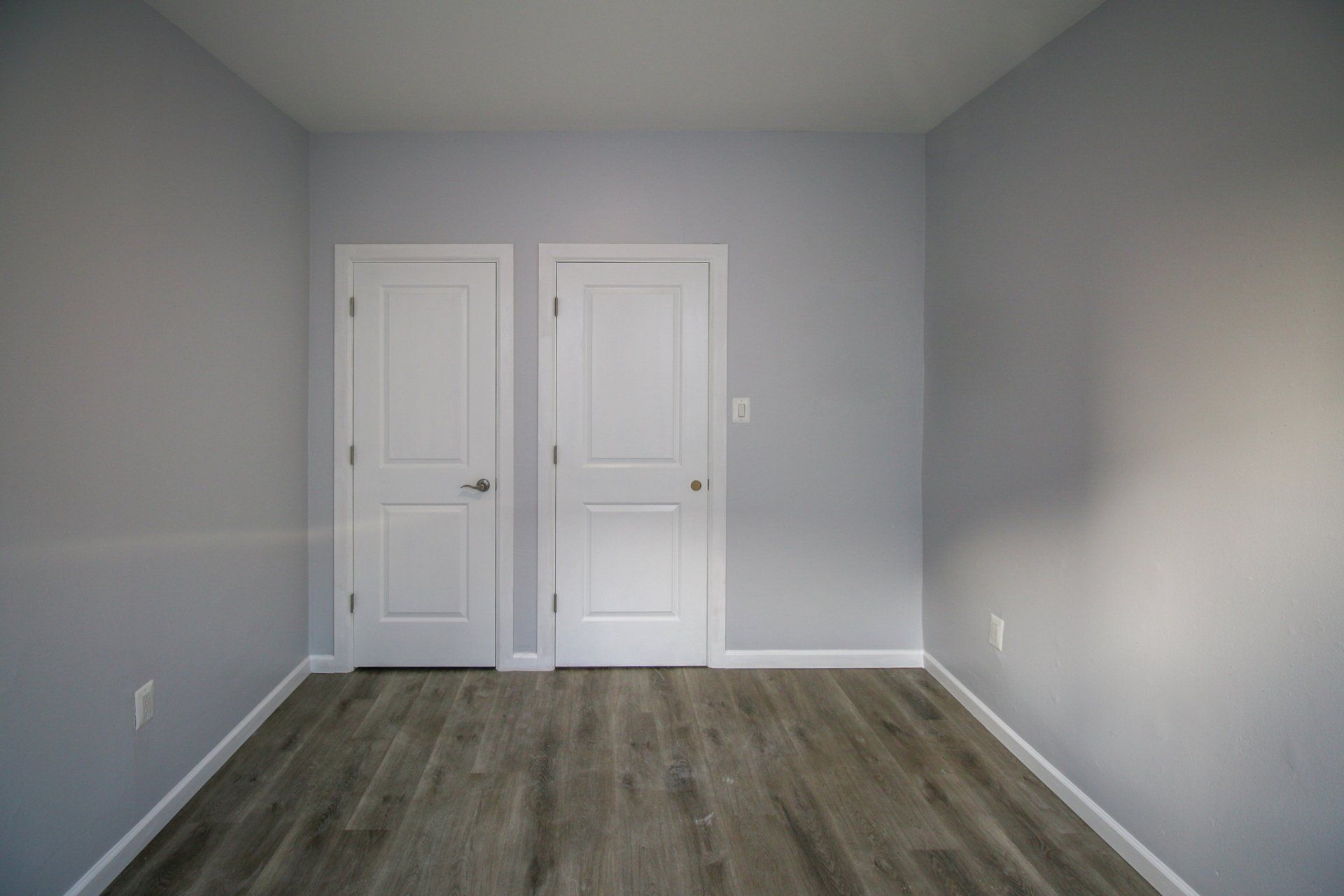 Updated bedroom with grey flooring