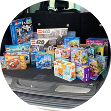 Assorted colorful toy boxes packed in an open car trunk