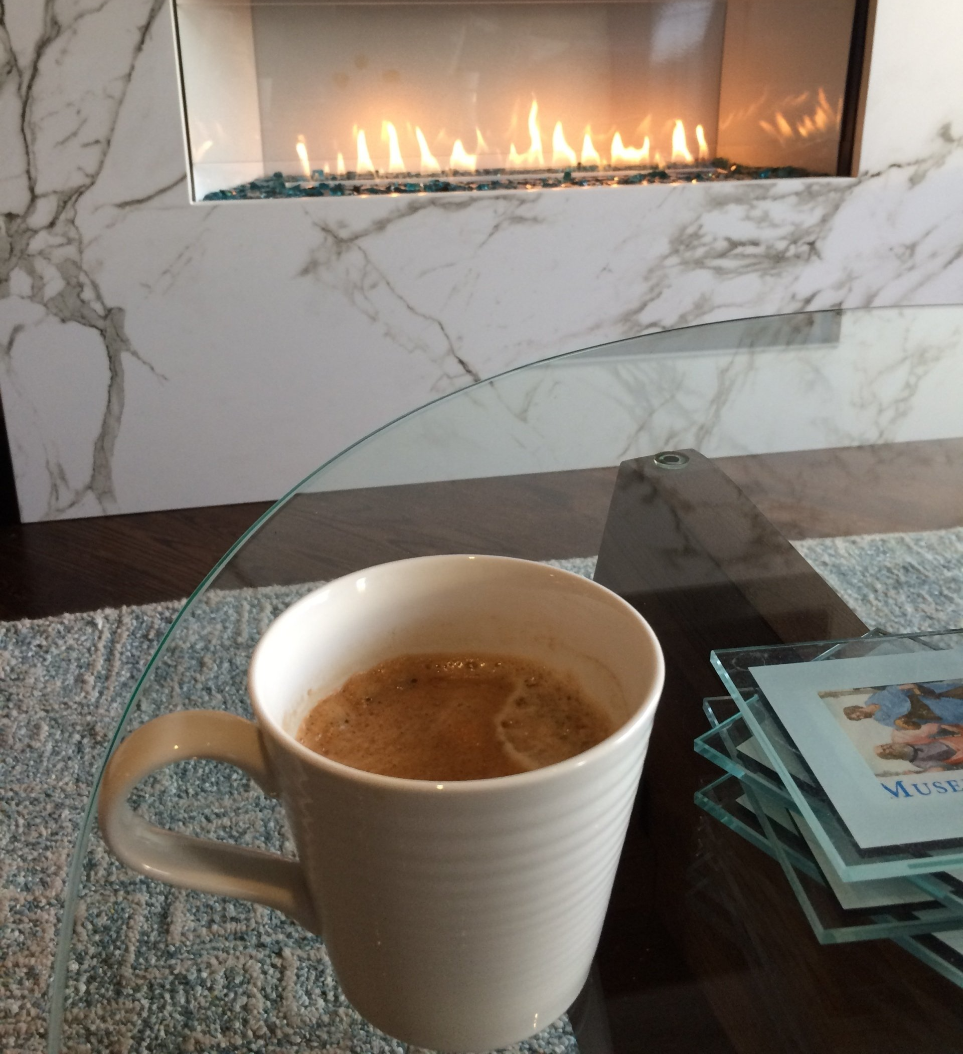 Coffee cup on table in front of fireplace