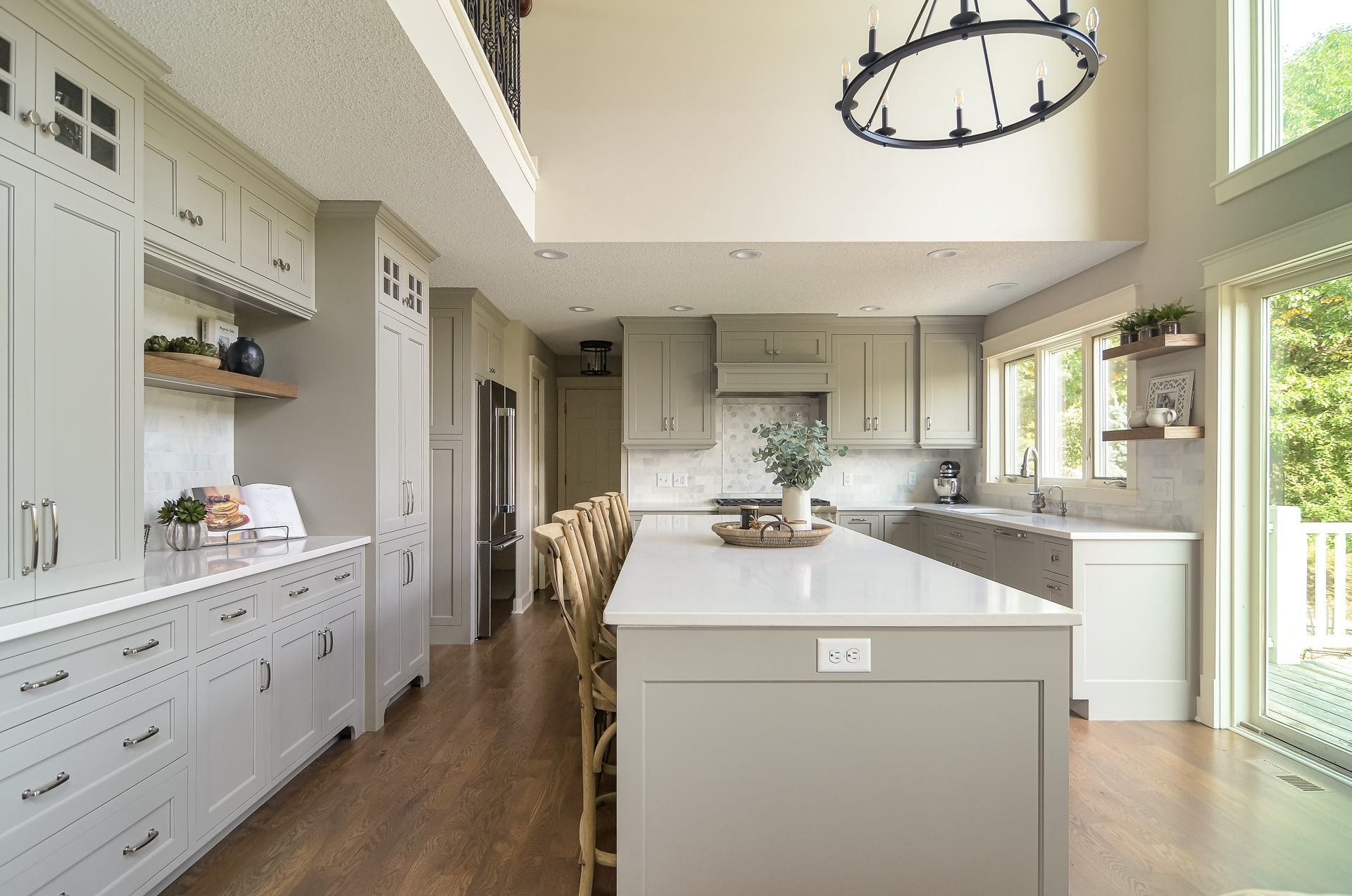 kitchen remodel with tall ceilings large island and floor to ceiling windows