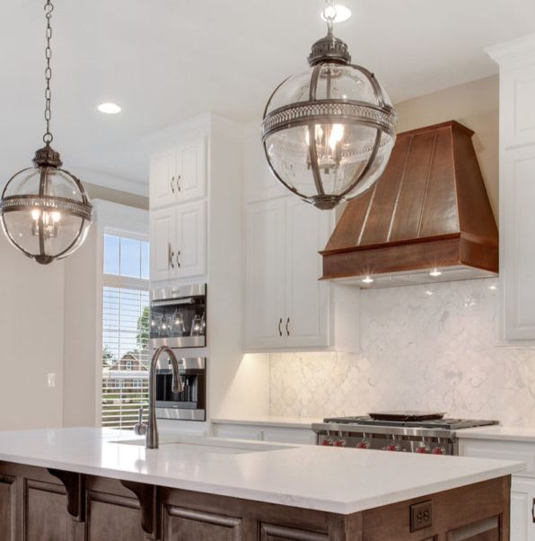 custom kitchen with hammered copper range hood