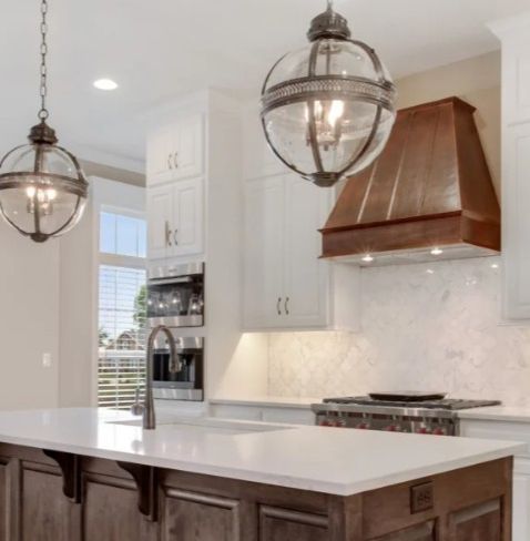 custom kitchen with handcrafted copper range hood