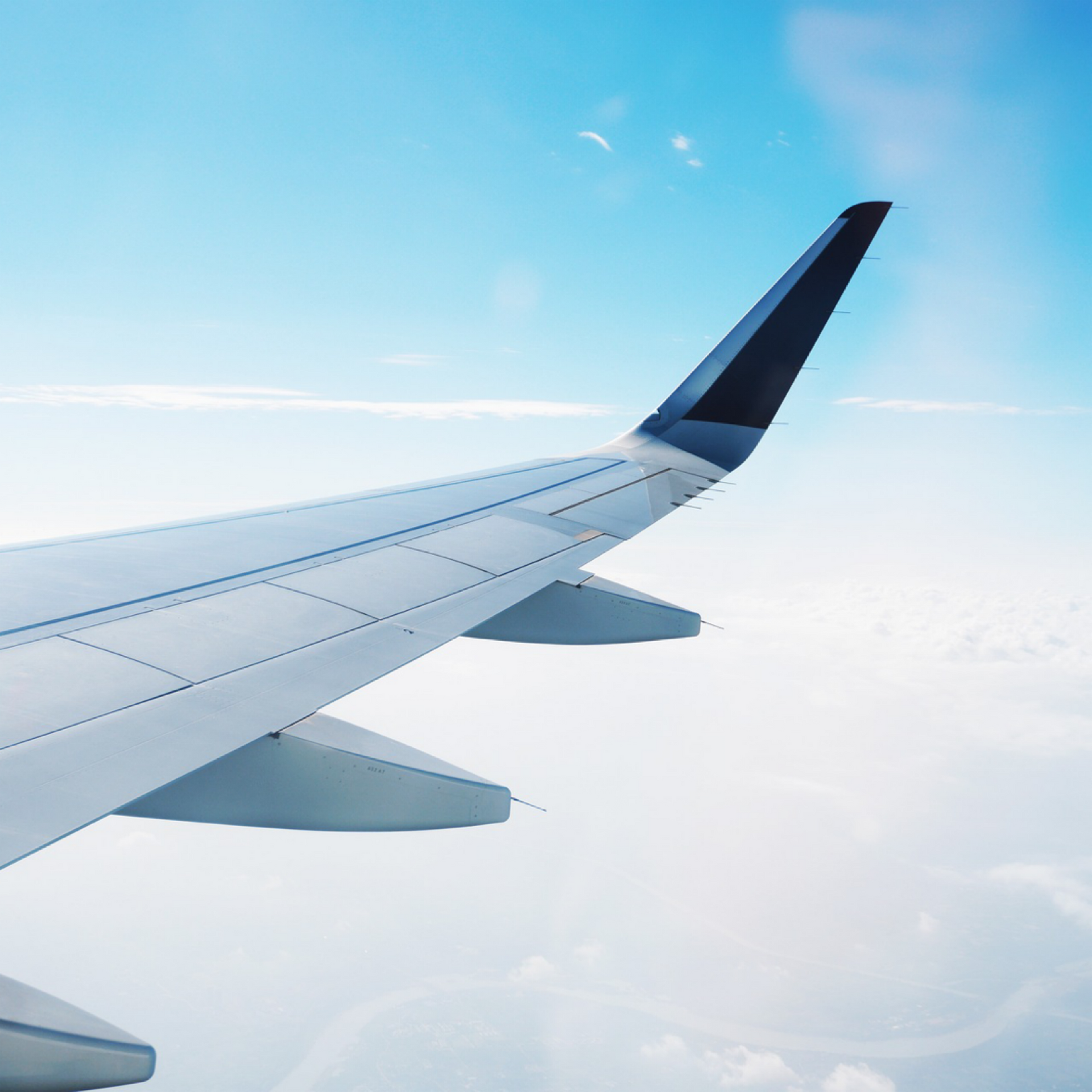 airplane in flight with blue sky