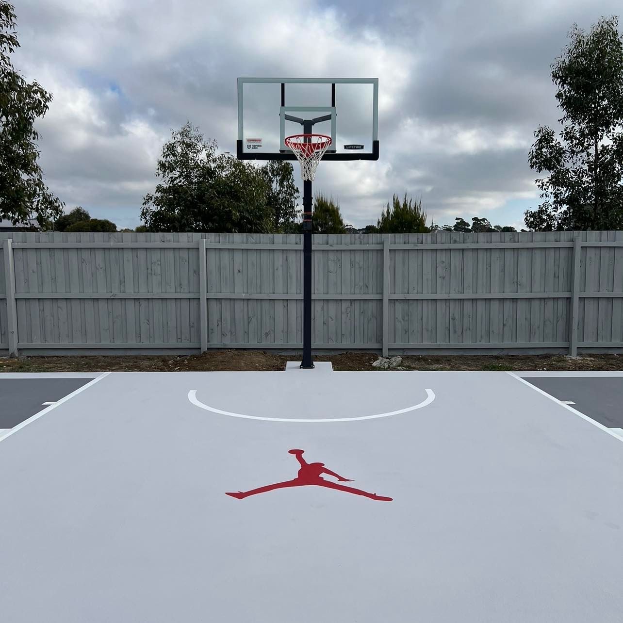 A white basketball court with a red air jordan logo