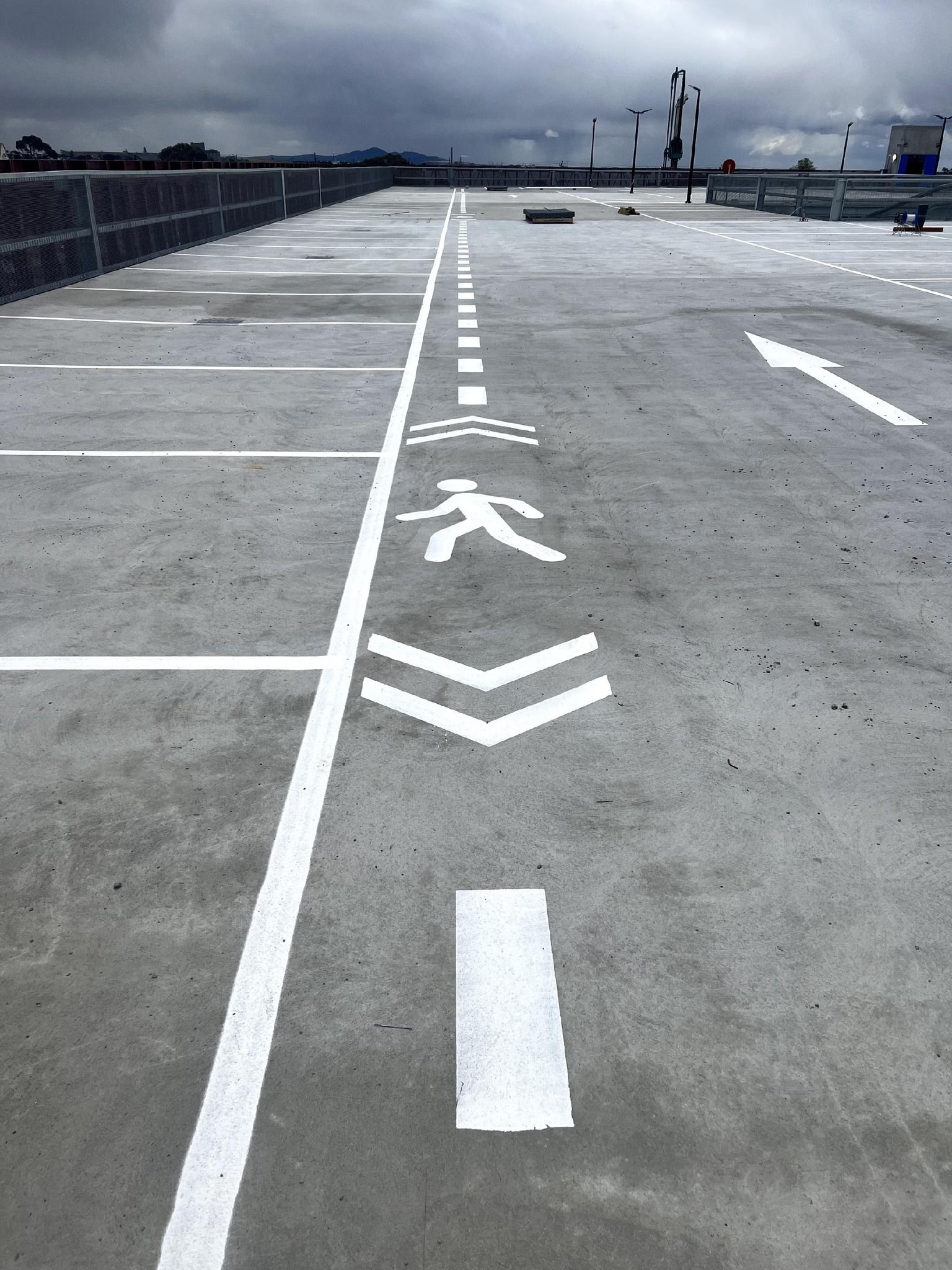 A parking lot with arrows painted on the ground