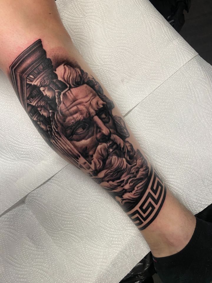 Realistic tattoo of a Greek god and pillars in the back, made in Aarau by Costa