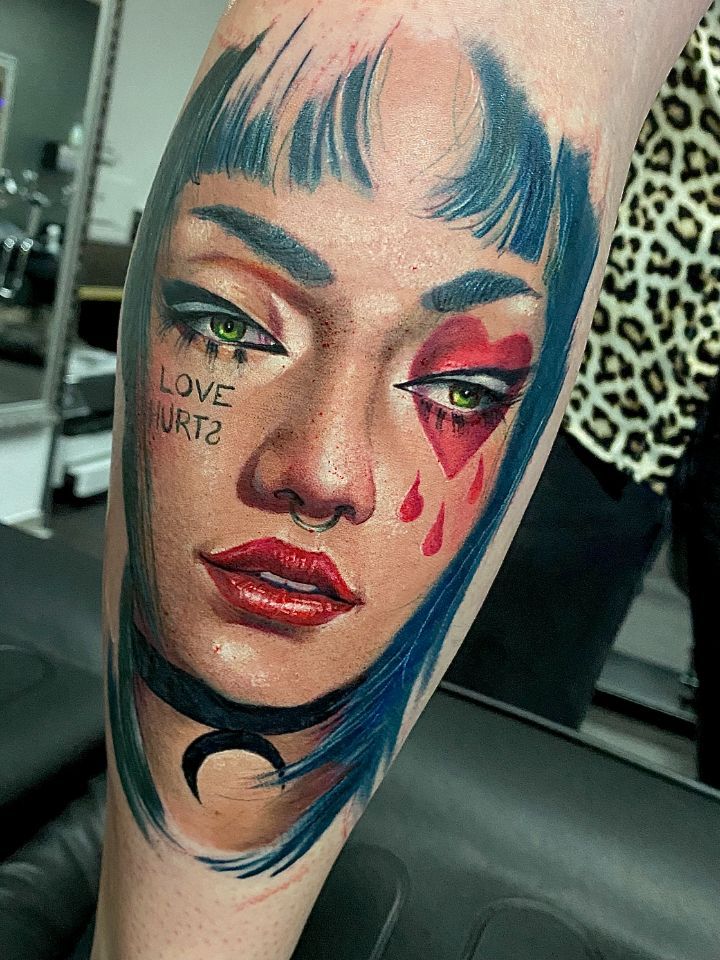 Realistic portrait of a woman with tattoos, a nose ring and blue hair, Made in Aarau by Costa