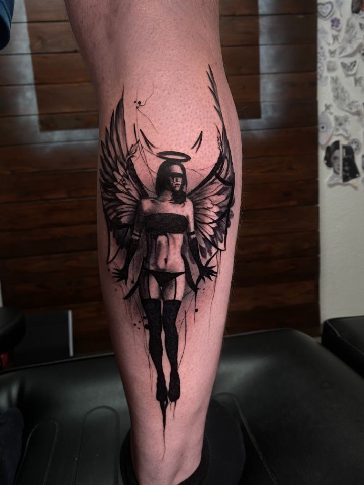 Dark Realistisch tattoo of an angel, demon woman with wings, horns and a halo, Made in Aarau by Costa