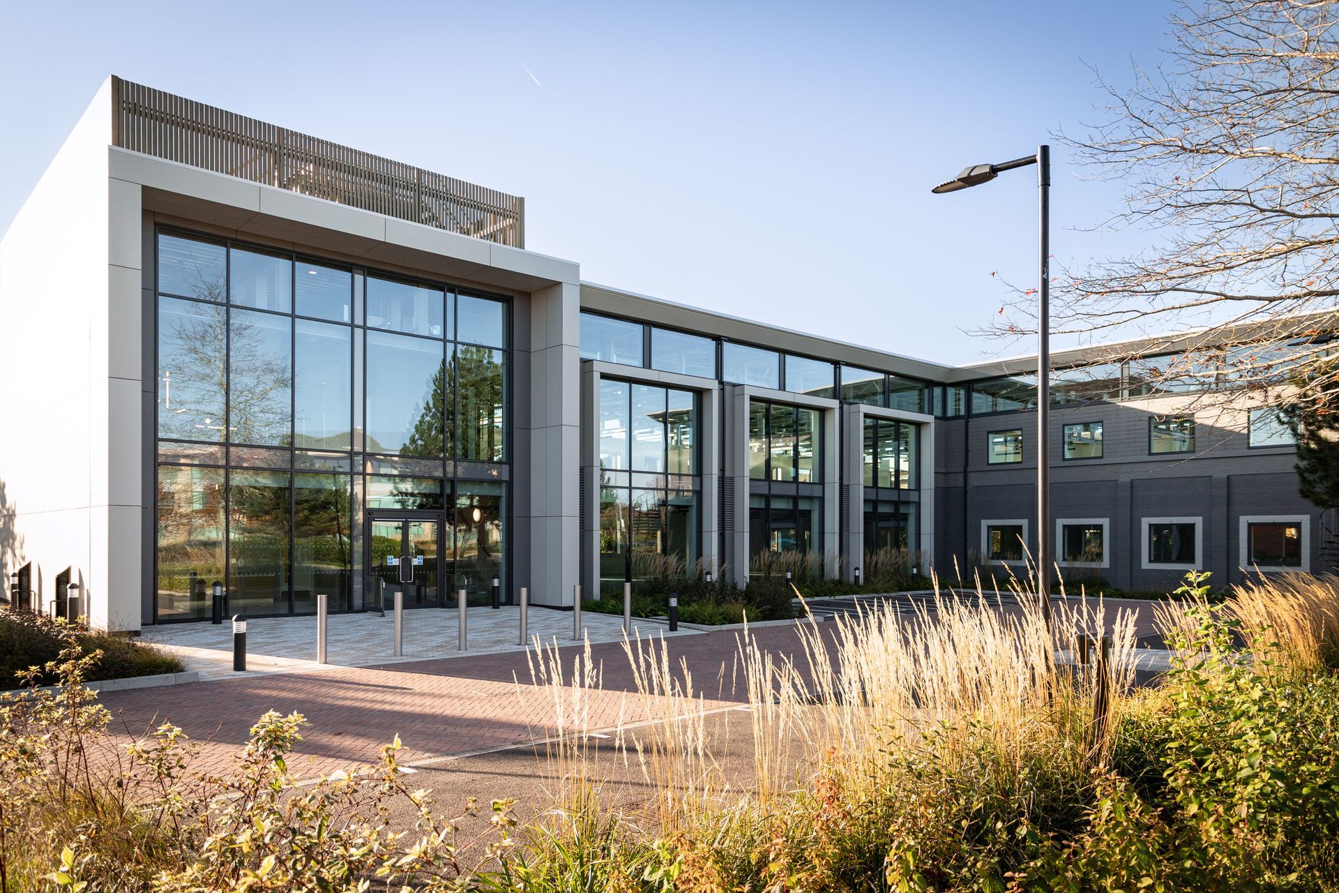 Office building at ARC Oxford with large glass windows and rectangular design, surrounded by landscaping.