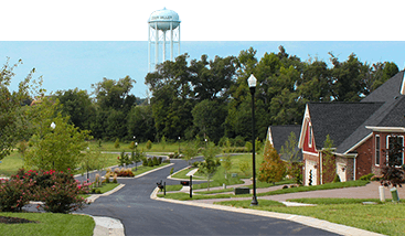 a residential neighborhood with a water tower in the background