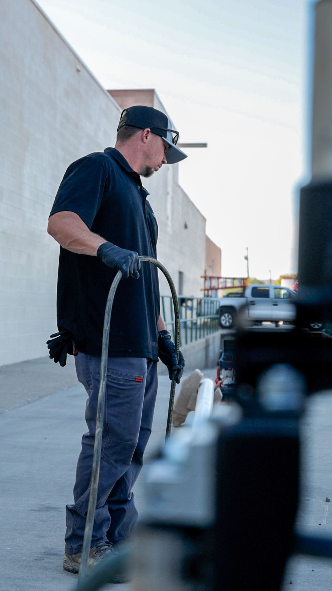A white water heater is surrounded by copper pipes