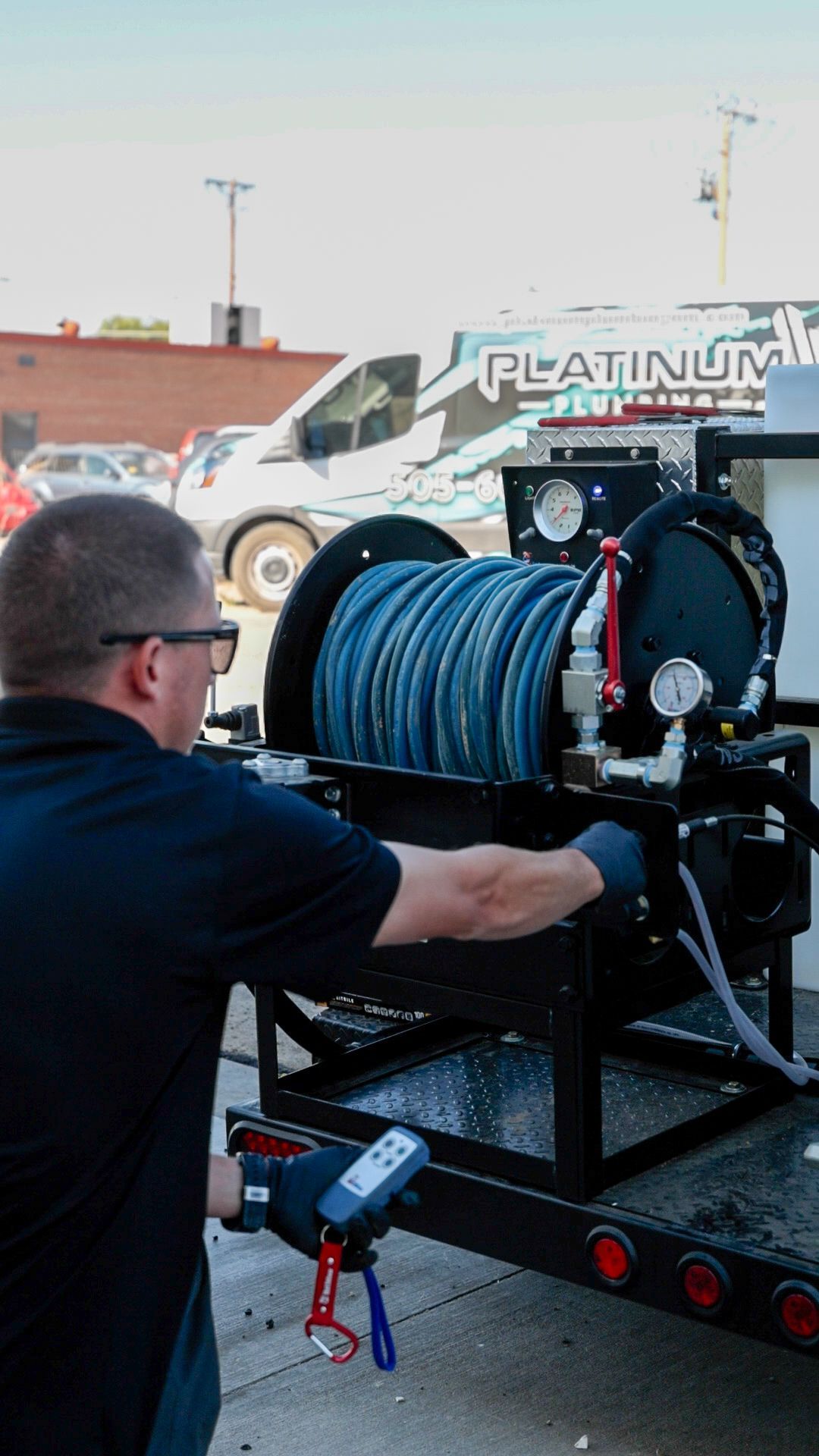 A man is fixing a water heater on the wall.