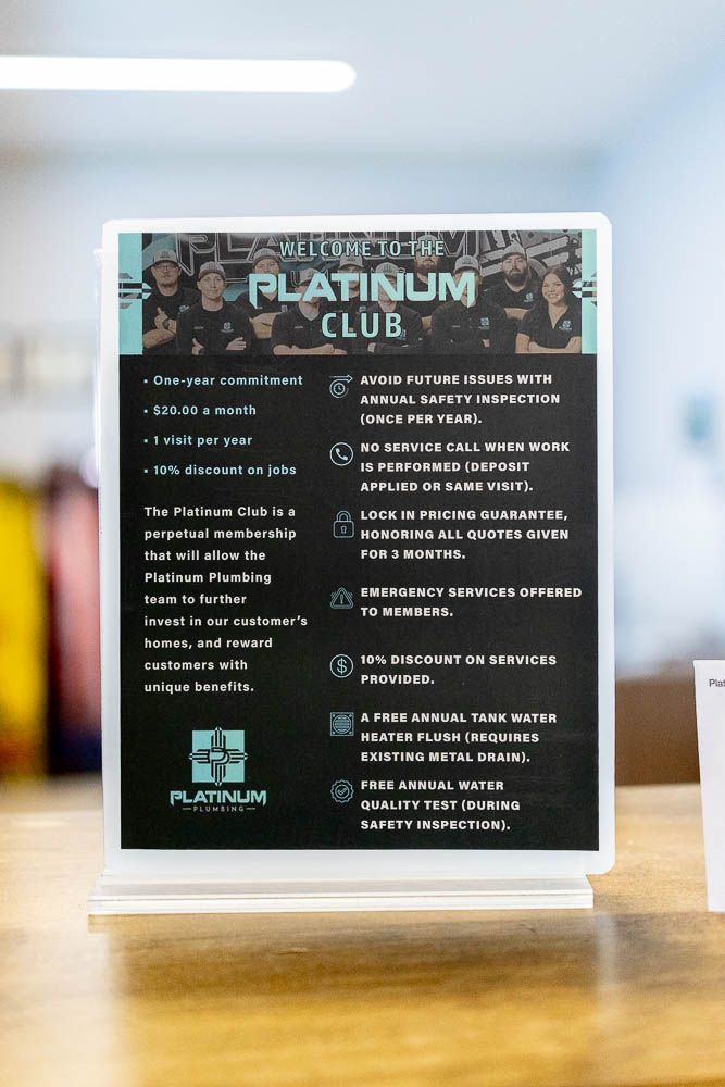 Platinum Club sign on a tabletop stand with white text on a dark background in a bright indoor space