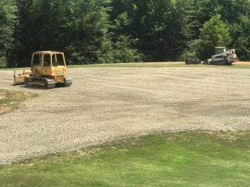 Excavating vehicles in a field
