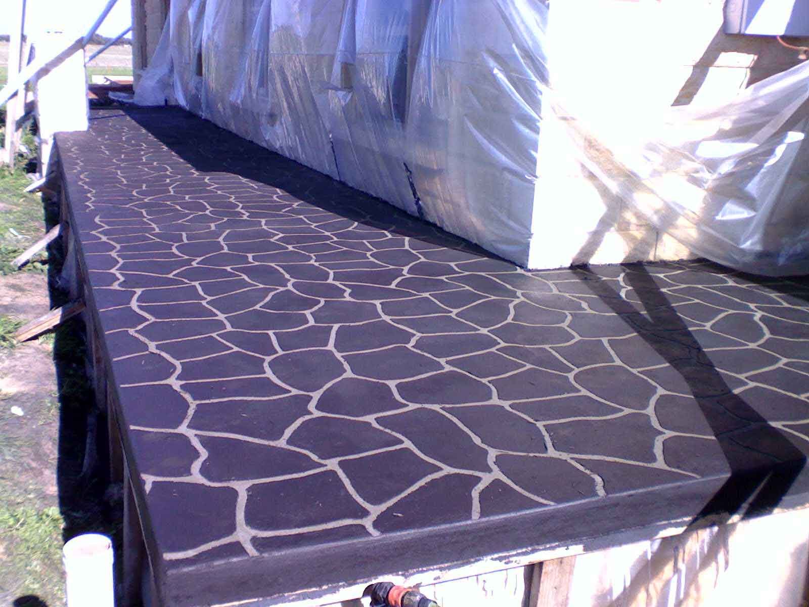 A concrete walkway with a geometric pattern on it