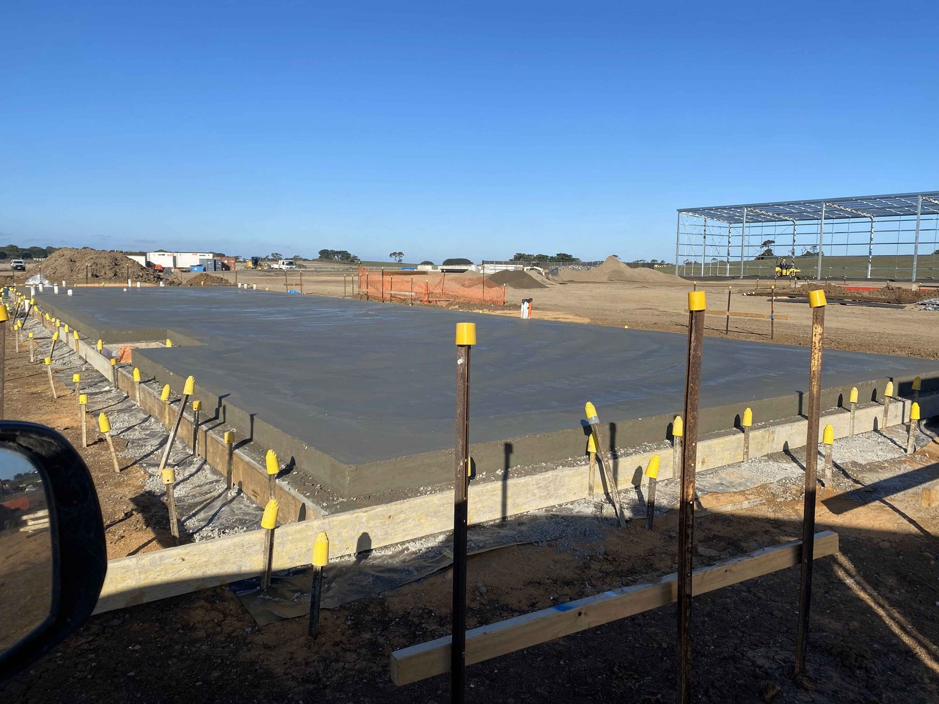 A construction site with a lot of yellow markers on the ground
