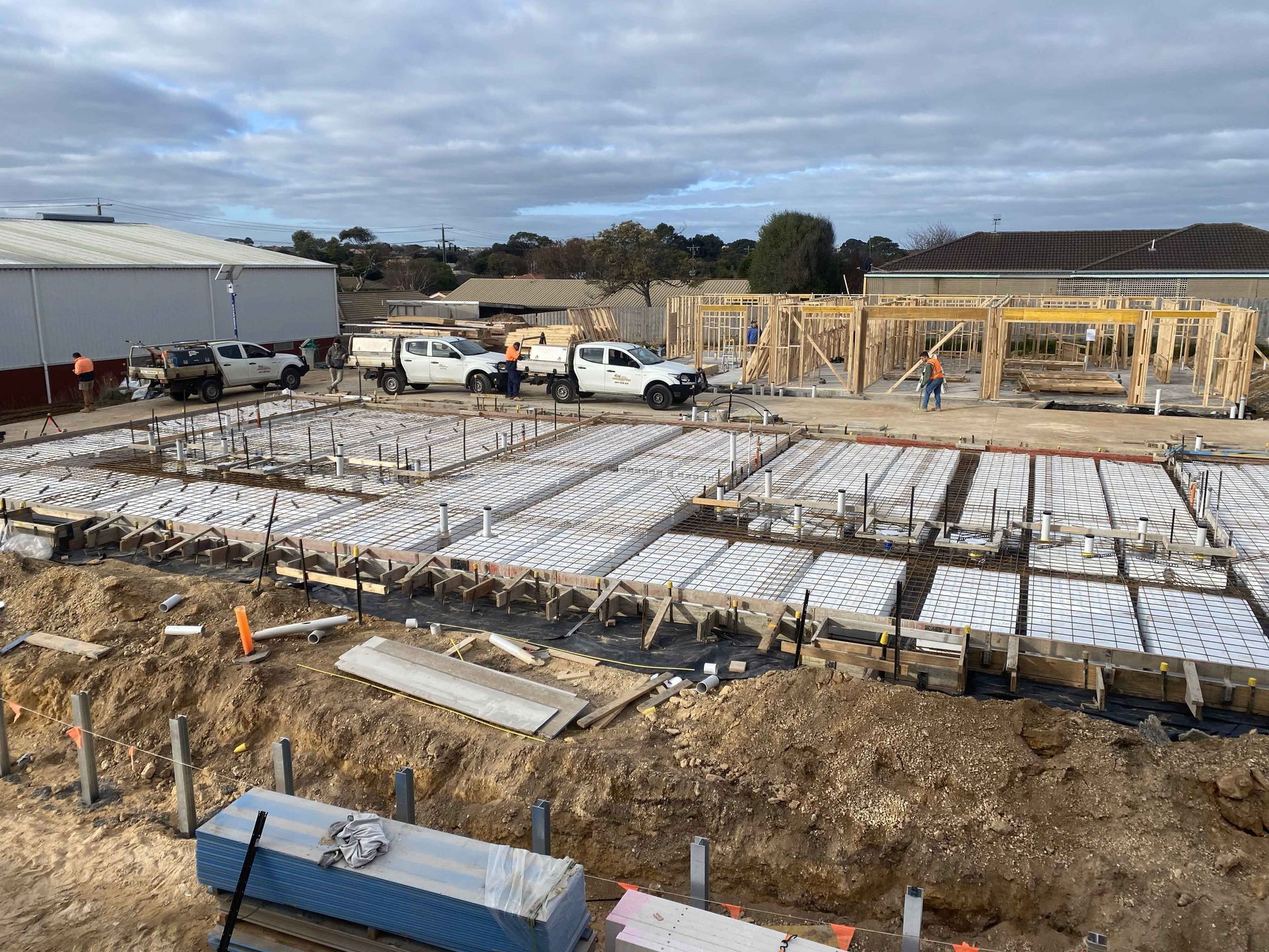 An aerial view of a construction site with trucks parked in the dirt.