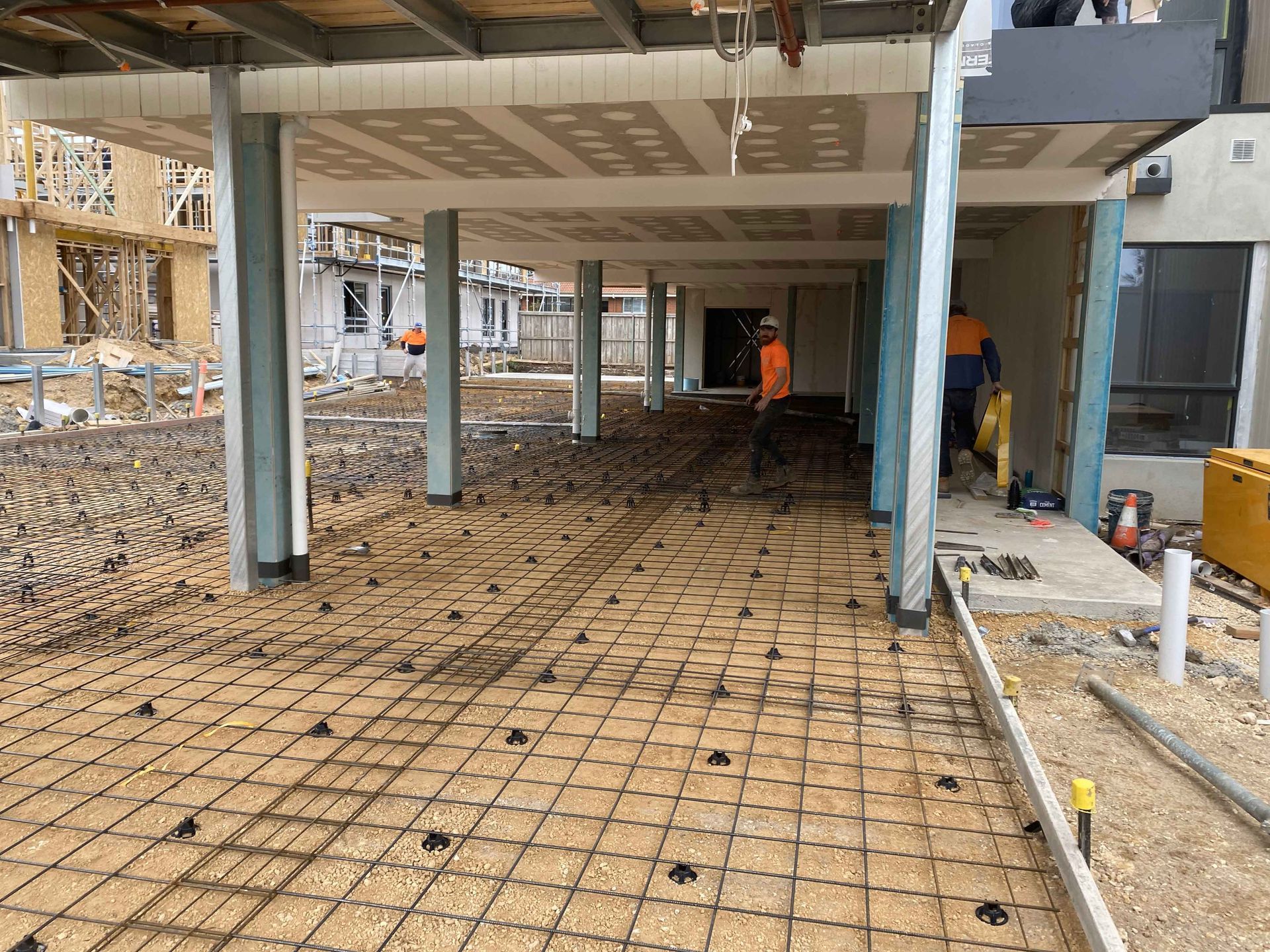 A group of construction workers are working on a building under construction.