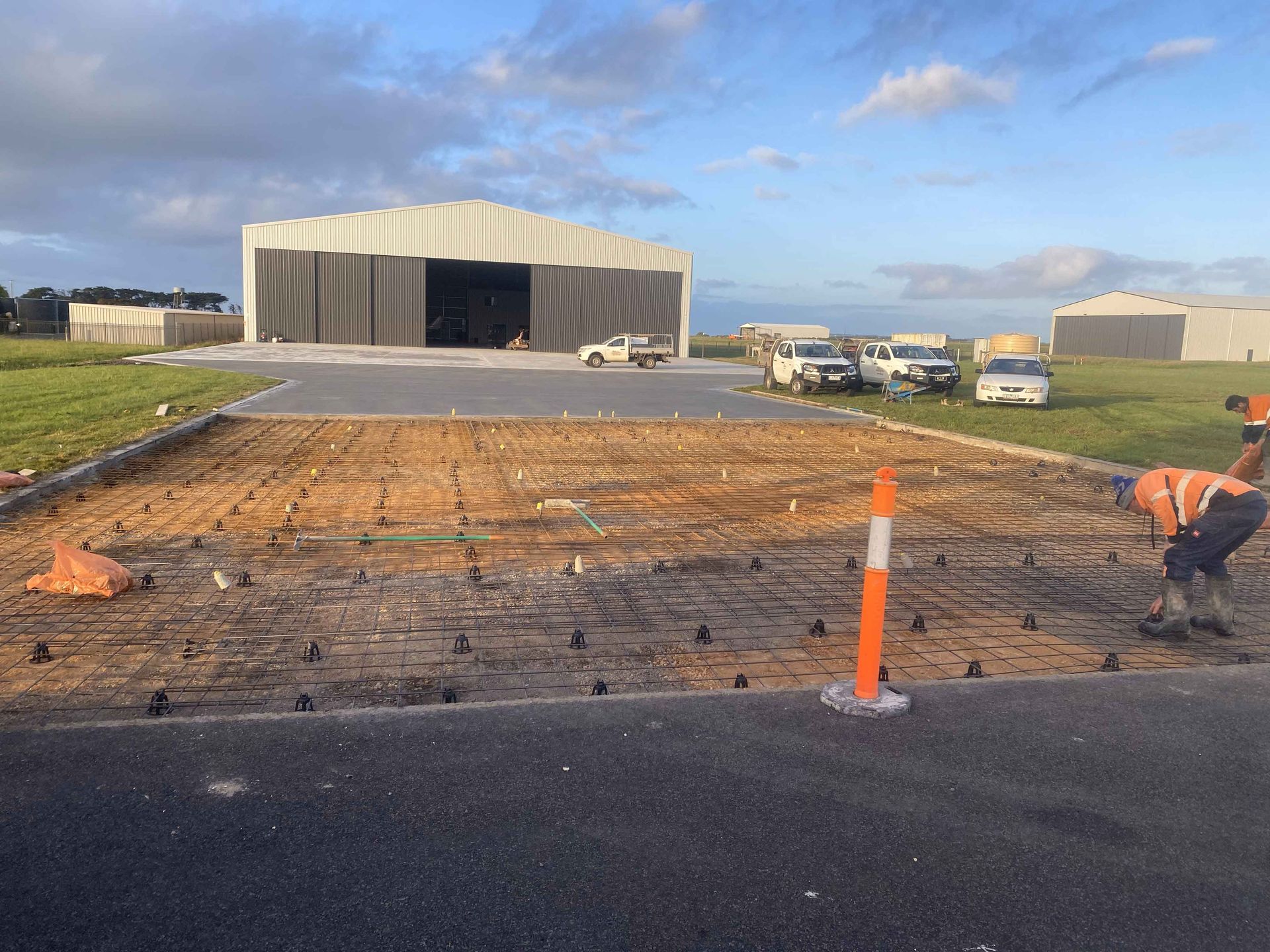 A man is working on a road in front of a building.