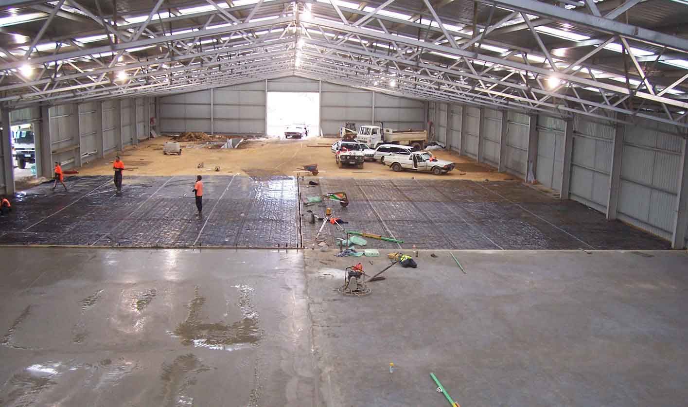 A large warehouse with a lot of people working inside of it